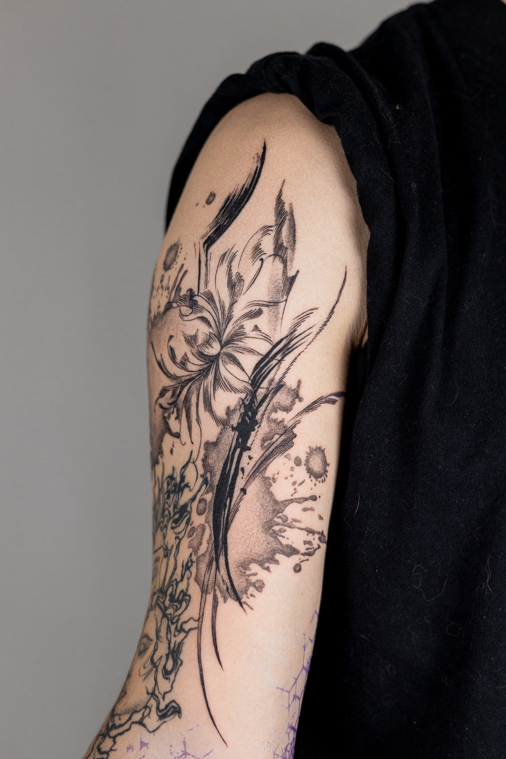 Tattoo on a person's arm with a black background